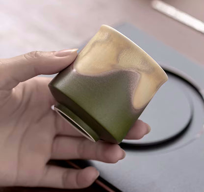 Admiring Oriental Traditional Tea Cup In Earthy Green Tones