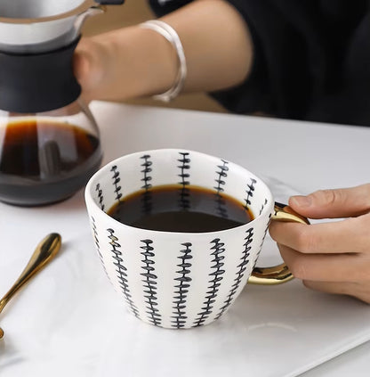 Cup Of Coffee Gold Handled Coffee Mug With Black And White Stitching Artistic Pattern