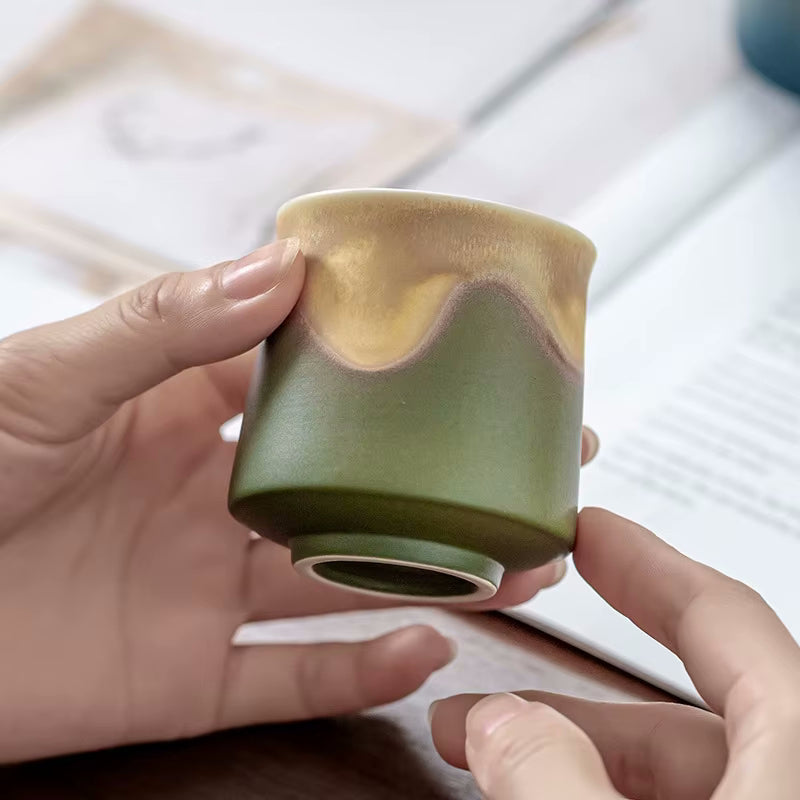 Holding Small Tea Cup In Earthy Green Tones Oriental Traditional No Handle Mug